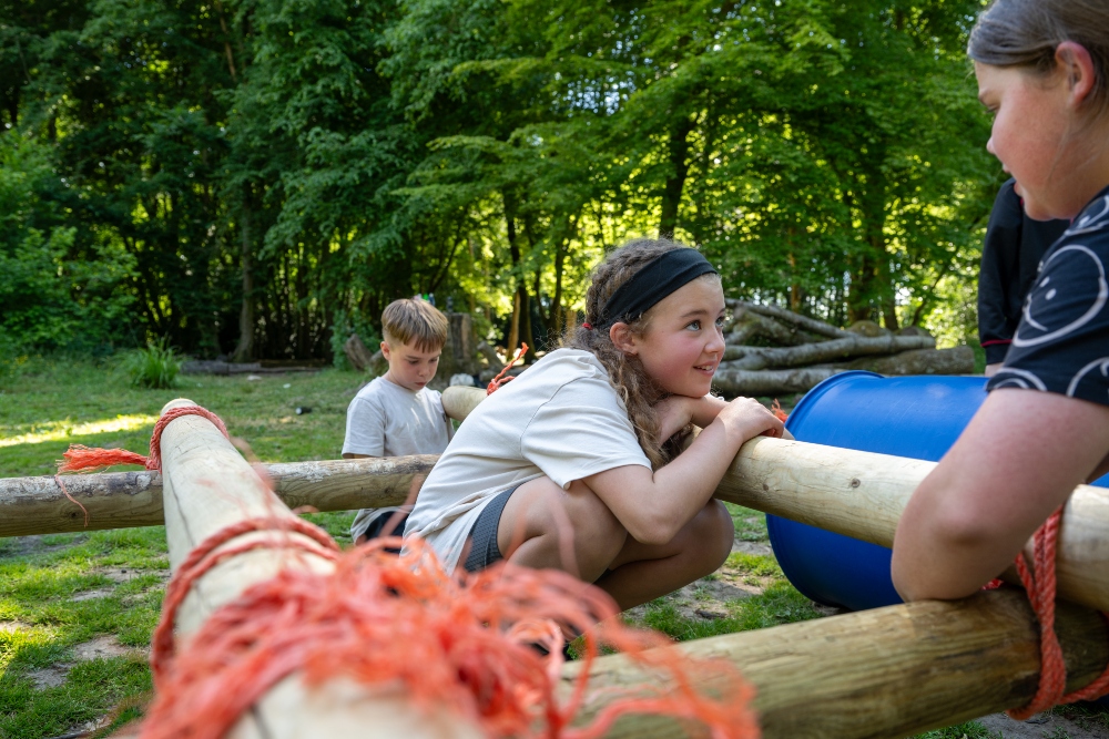 group of children building buggy in woodlands