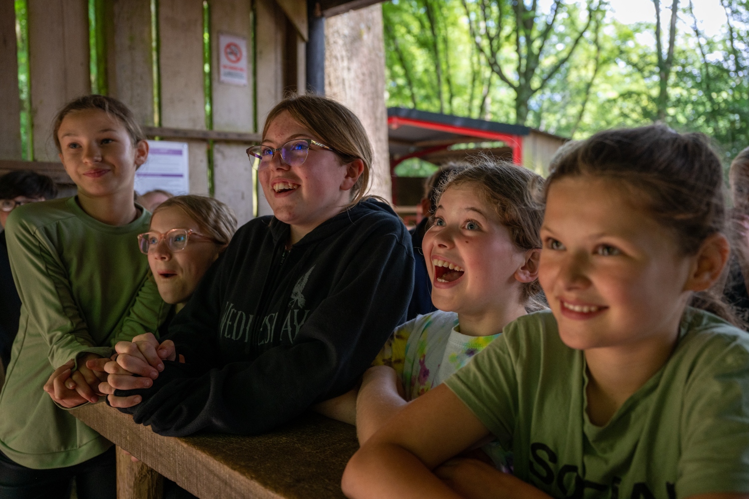 girls smiling at archery range